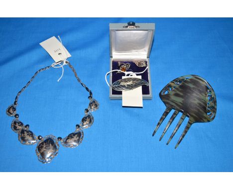 A tortoiseshell effect hair comb; together with a quantity of Siamese silver jewellery, including: a necklace; brooch; and si