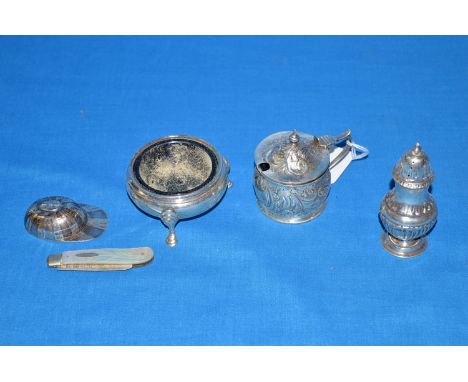 Silver condiments, to include: a cauldron pattern table salt; an embossed mustard pot; a pepperette; a reproduction jockey ca
