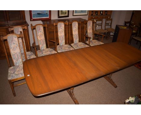 A modern Ercol eight-piece stained dining suite, comprising; sideboard with drawers cupboards and carved panel doors; an exte