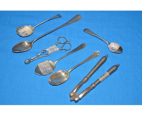 Silver items, to include: a preserve spoon; a pair of sugar tongs; a reproduction trefid spoon; and a plated nut cracker.