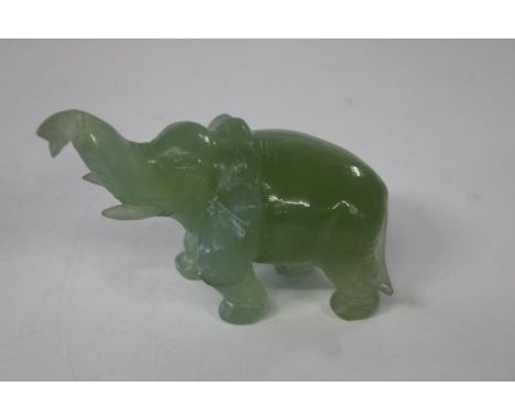 A small jadeite model bull elephant with trunk up. 10cm x 7cm 