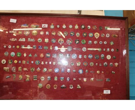 A large selection of assorted enamel badges in a glazed frame collection only 