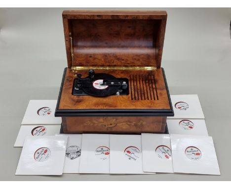 A Reuge 'Romance Treasure Chest' walnut and marquetry dome top disc playing music box, 32cm wide, with eleven 4 1/2in discs. 