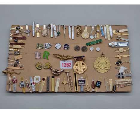 A collection of tie pins and badges.&nbsp; 