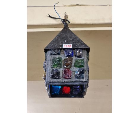A black painted metal and coloured glass ceiling lantern, 31cm high. 