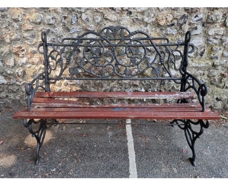A cast iron garden bench, with wood slats, 122cm wide. 
