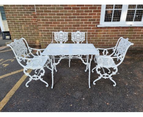 A Victorian style white painted aluminium garden suite, comprising: a table, 93.5cm wide; a two seater bench, 97cm wide; and 