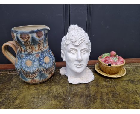 A Quimper salt glaze jug, 23cm high; together with a pottery head; and a Sarreguemines preserve pot, cover and stand, (heavil