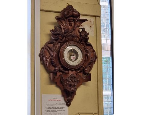 A large carved oak aneroid barometer, 78cm high.&nbsp; 