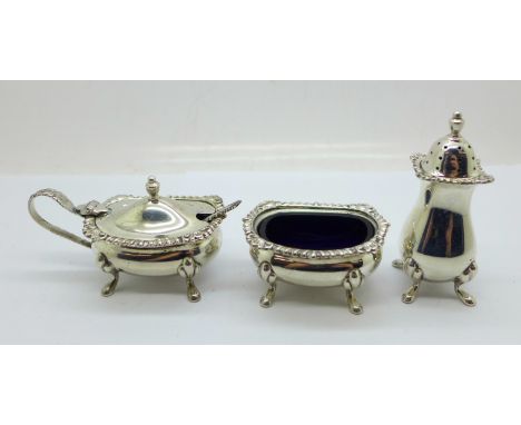 A three piece silver cruet set with blue glass liners, 126g of silver 