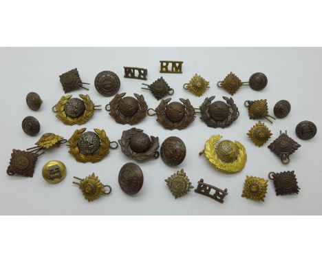 A tin of regimental badges and buttons, including Royal Marines, Light Infantry, pips, etc. 