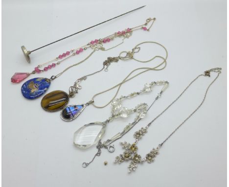 Jewellery including a hat pin, silver mounted pendants, butterfly wing pendant and three necklets 