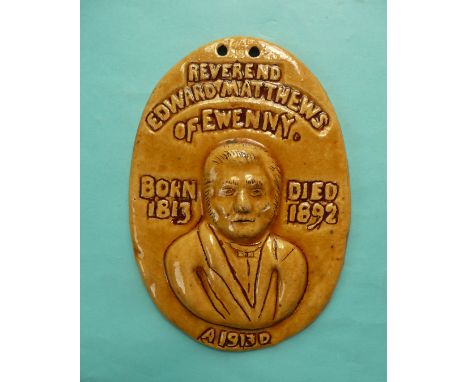 (Commemorative) 1913 Ewenny: an oval Ewenny Pottery plaque modelled in bold relief with an inscribed portrait of the Reverend