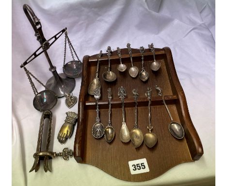 RACK OF SOUVENIR TEASPOONS MAINLY CONTINENTAL SILVER AND WHITE METAL, BALANCE SCALE, CLASPING HAND PAPER CLIP, AND MINIATURE 