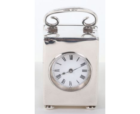 An Edwardian silver carriage clock, Mojon &amp; Co Ltd, London 1907, scrolling top handle, plain body, on four bun feet, 5.5c