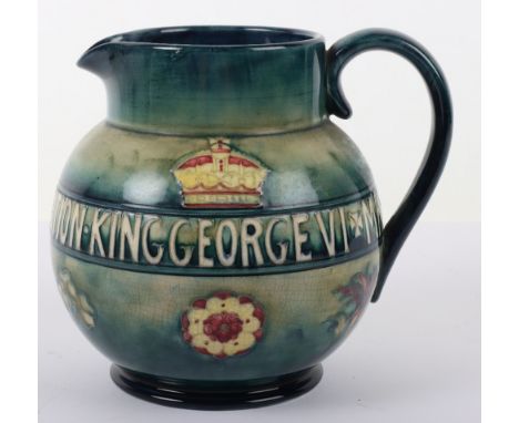 A Moorcroft George VI Queen Elizabeth 1937 Coronation jug,  with royal emblems against a mottles blue/green ground, marks to 