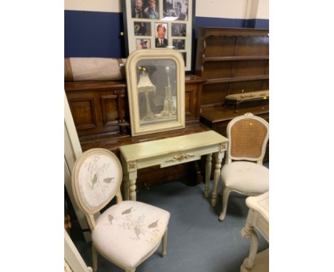 A modern cream console table together with a cream mirror and two bedroom chairs