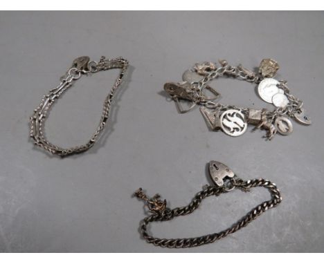 A silver charm bracelet together with a silver gate bracelet