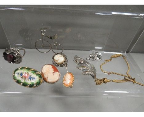 A small bag of costume jewellery to include a cameo and an amethyst  style ring