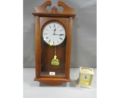A wall clock together with a carriage clock