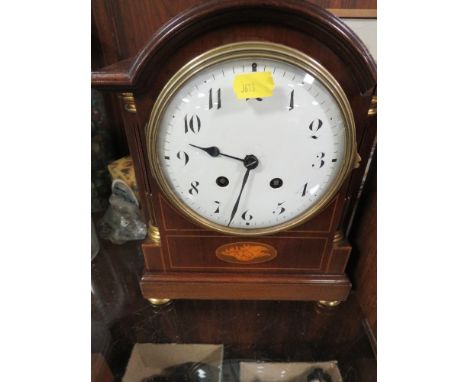 An antique inlaid mantle clock