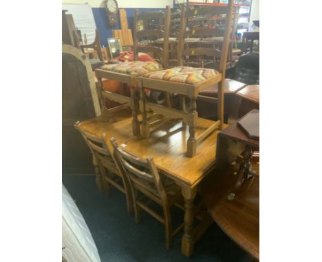 An oak draw leaf refectory style table together with four ladder back oak chairs