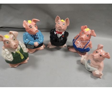 A collection of five Wade NatWest piggy banks