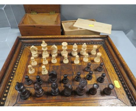 Two boxed wooden chess sets together with a parquetry tray