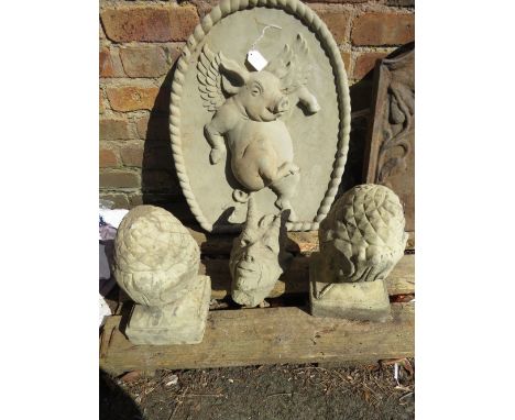 Four concrete garden ornaments to include a flying pig plaque