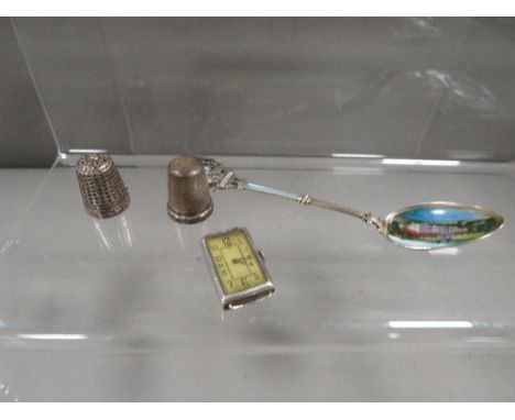 An Art-Deco silver cased wristwatch, 2 silver thimbles, silver and enamel spoon