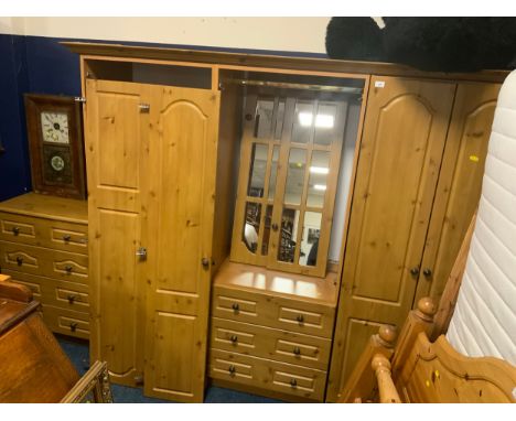 A modern pine effect wardrobe and chest of drawers