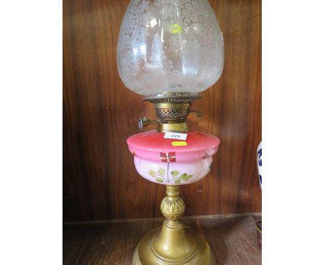 A vintage oil lamp with glass edge shade