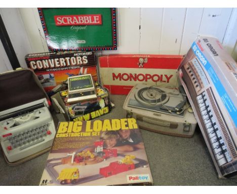 A collection of games etc to include monopoly, Palitoy big loader, Grandstand deltarian fighter, child's typewriter, reel to 