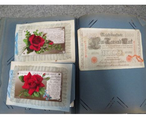A vintage postcard album and contents