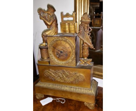 A Wonderful 19th Century French Empire Ormolu Figural Cased Mantel Clock; the dial surmounted with a stand of sheet music, fl