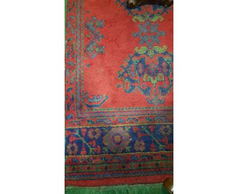 A Turkey Wool Carpet with Red Ground Field; with typical geometric decoration in a blue and green colourway 400 x 235 cm appr