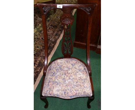 A 19th Century Mahogany Nursing Chair; the stuffed seat upholstered in floral patterned tapestry and standing on cabriole sup