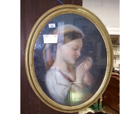 A 19th Century Continental Oval Pastel Portrait of a Girl Reading, having a Paris trade stamp verso and mounted in an oval gi