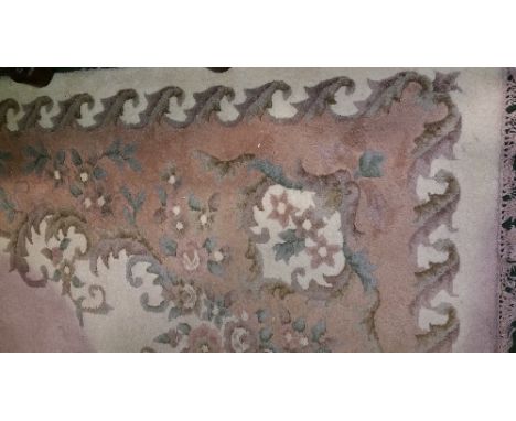 An Indian Wool Carpet; with a central medallion on an off white ground and a foliate border. 9ft x 12ft.