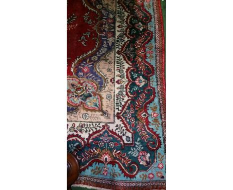 A Multicoloured Medallion Persian Tabriz Carpet on Red Ground. 370 x 297cm.