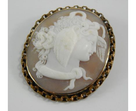 A shell cameo brooch bust portrait of Medusa, in an oval yellow metal frame, 5cm x 4cm.