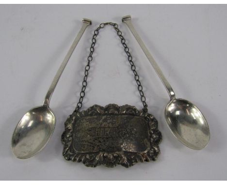 A silver sherry decanter label, London 1973, and a pair of Mappin & Webb silver seal top coffee spoons, 0.825t oz.