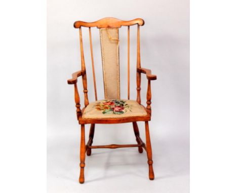An Edwardian oak country chair, with wool work back and floral tapestry seat, raised on turned legs.
