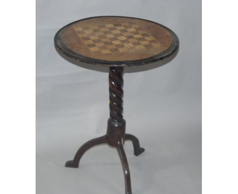 A Victorian mahogany circular games table, with chess board inlay, on ebonised barley twist tripod column supports, 63cm high