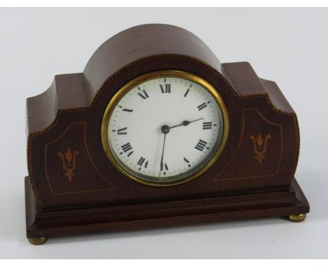 An Edwardian mahogany and inlaid mantel clock, enamel dial bearing Roman numerals, French movement, raised on brass feet, 22c
