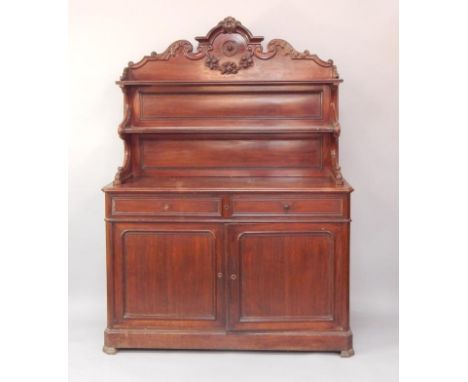 A Victorian mahogany sideboard, the double shelf back carved with leaves and fruit, above two drawers, with cupboards below, 