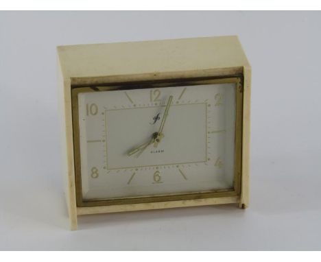 A German cream Bakelite savings alarm clock, white rectangular dial bearing Arabic numerals with key, 12cm x 5cm x 10.5cm