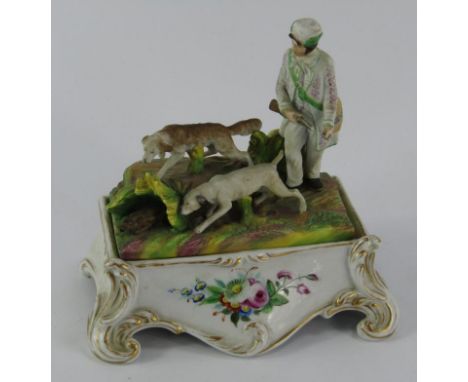 A French porcelain desk stand, late 19thC, the bisque lid moulded with a hunter and hounds pursuing a hare, the base of rococ