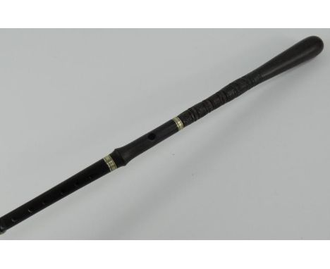 An African blackwood walking stick flute, with a turned handle and metal banding, 91.5cm long