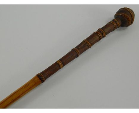 A bamboo sword stick, early 20thC, the upper sheath and knop with pared down carving and frilled bands, 95cm long